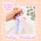 Three custom acrylic keychains in pastel pink, light blue, and lavender, each featuring a raised white script name. The names Adaline, Kristen, and Juliette are visible. Each keychain is attached to a silver metal cable ring.